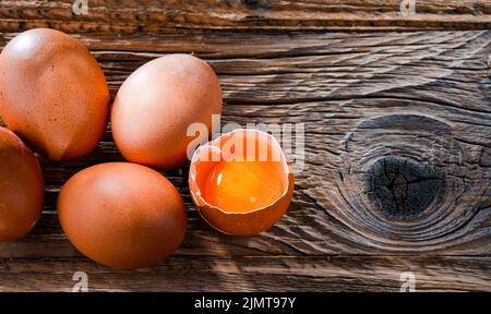 Composition with five chicken eggs on a wooden table. Stock Photo