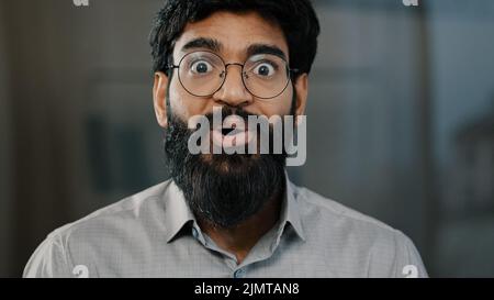 Male portrait surprise emotion enthusiastic surprised shocked arabian amazed man in eyeglasses make big eyes indian businessman winner demonstrate wow Stock Photo