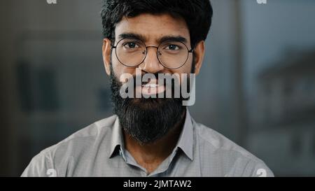 Young guy hispanic handsome bearded man smiling looking at camera male portrait brunette indian businessman assistant manager entrepreneur posing Stock Photo
