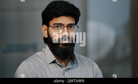 Arab hispanic handsome bearded man confident brunet guy in eyeglasses turn head at camera with positive facial expression indian young intelligent Stock Photo