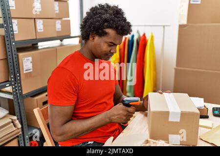 Young south east man using barcode reader device working at storehouse Stock Photo