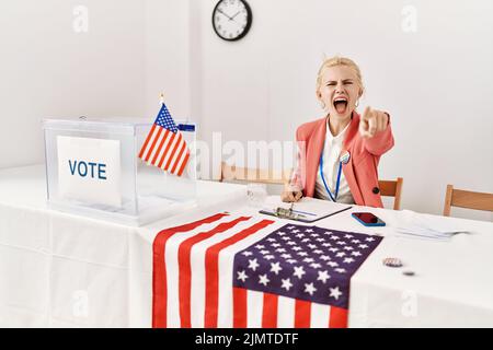 Beautiful caucasian woman working at political campaign pointing displeased and frustrated to the camera, angry and furious with you Stock Photo