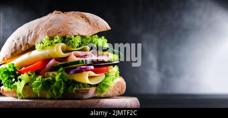 Sandwich with cheese and ham and fresh vegetables Stock Photo