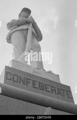 Confederate monument stands across from the Dooly County Courthouse in Vienna, Georgia. A likeness of a Confederate Army soldier stands . Stock Photo