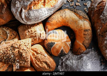 Assorted bakery products including loafs of bread and rolls Stock Photo