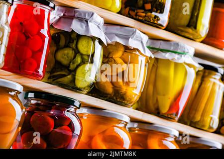 Jars with variety of marinated vegetables and fruits Stock Photo