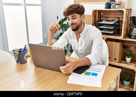 Young arab man using laptop working at office Stock Photo