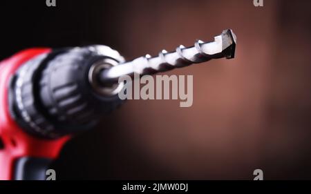 Composition with a cordless drill also working as a screw gun Stock Photo