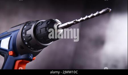 Composition with a cordless drill also working as a screw gun Stock Photo
