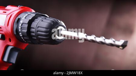Composition with a cordless drill also working as a screw gun Stock Photo