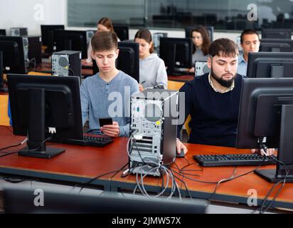 Computer lessons for adults in classroom Stock Photo