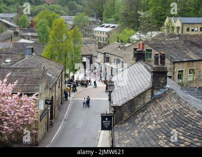 Panoramic view of the town of hebden bridge with people outside pubs and bars in the town square Stock Photo