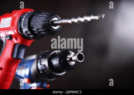 A pistol-grip cordless drill and a screw gun. Stock Photo