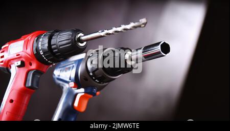A pistol-grip cordless drill and a screw gun. Stock Photo