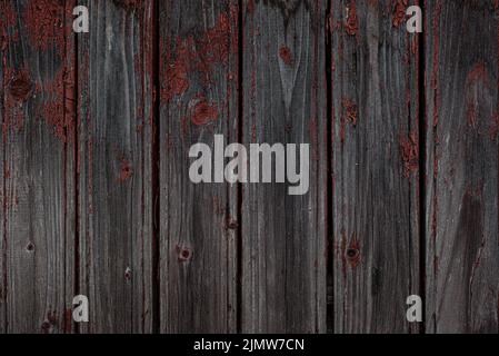 Old natural weathered wooden planks with cracked red paint background Stock Photo