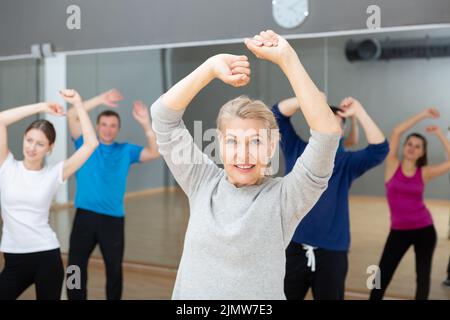 Mature woman practicing vigorous dance Stock Photo