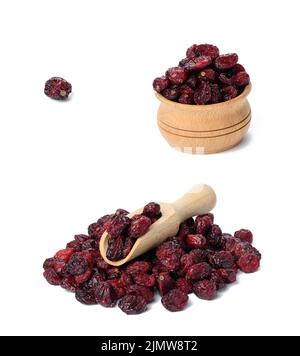 A bunch of dried cranberries in a wooden bowl on a white background. Delicious berry Stock Photo