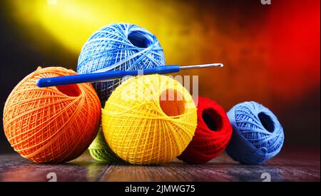 Composition with assortment of different colored yarns and hook for crocheting Stock Photo