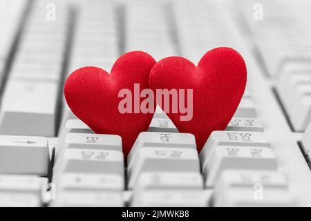 Small red hearts on keyboard Stock Photo