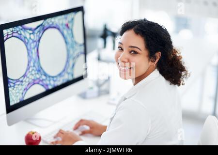 This discovery could lead to a cure. a female scientist using her computer while sitting in a lab. Stock Photo