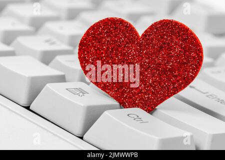 Single red heart on computer keyboard Stock Photo