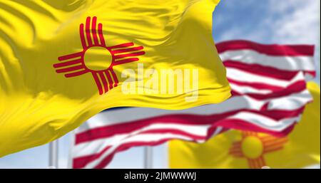 The New Mexico state flag waving along with the national flag of the United States of America Stock Photo