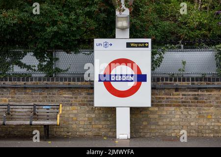 London Underground Tube Station name sign for Debden Station on the Circle Line. Stock Photo