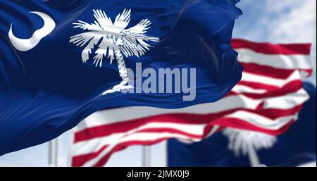The South Carolina state flag waving along with the national flag of ...