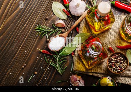 Flat lay food background made of oils condiments and spices on kitchen table. Cooking concept Stock Photo