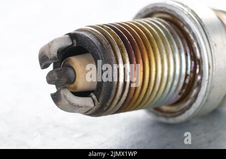 Closeup photo of old used spark plug for internal combustion engine. Space for text Stock Photo