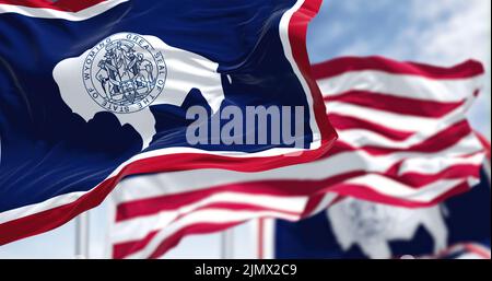 The Wyoming state flag waving along with the national flag of the US Stock Photo
