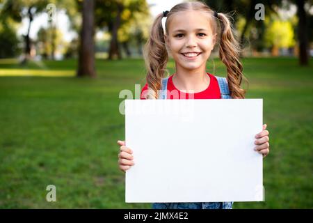 Happy girl holding empty banner her hand Stock Photo