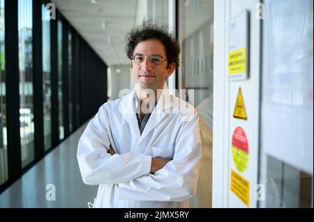 Berlin, Germany. 19th July, 2022. Molecular biologist Emanuel Wyler stands in front of the safety laboratory at the Max Delbrück Center for Molecular Medicine in Mitte, where wastewater samples are analyzed for pathogens. Conclusions can be drawn from the amount of bacteria and viruses found, for example on the frequency of corona infections. Credit: Bernd von Jutrczenka/dpa/Alamy Live News Stock Photo