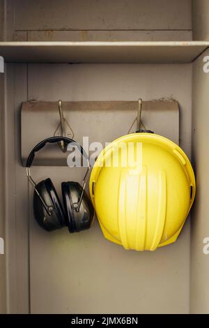 Front view headphones hard hat hanging closet Stock Photo - Alamy
