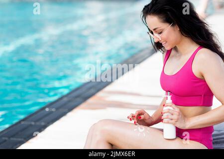 Front view woman using sunscreen Stock Photo