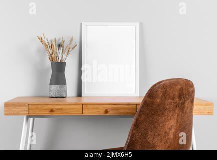 Frame mock up table beside vase Stock Photo