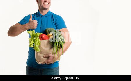 Front view delivery man with grocery bag thumbs up Stock Photo