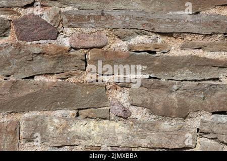 Old stone walll full frame background. Stock Photo