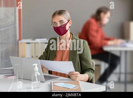 Co workers wearing face mask work Stock Photo