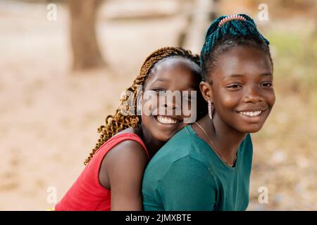 Close up smiley african girls outdoors Stock Photo