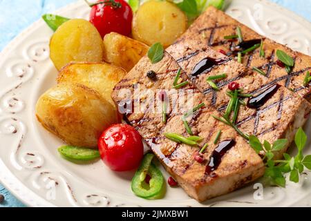 Tofu steaks with vegetables close up. Stock Photo