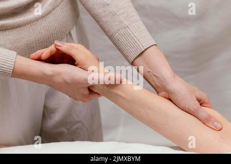 Close up therapist massaging patient s arm Stock Photo