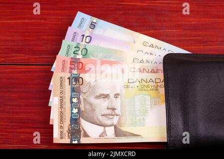 Old Canadian money in the black wallet Stock Photo