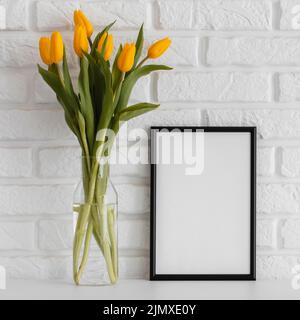 Bouquet tulips transparent vase with empty frame Stock Photo