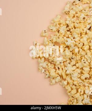 Heap of fried popcorn with cheese on a beige background Stock Photo