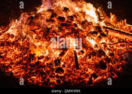 Burning coals from a fire abstract background. Stock Photo