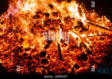 Burning coals from a fire abstract background. Stock Photo