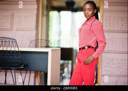 Pretty braids business african american lady bright bossy person friendly wear office red shirt and trousers. Stock Photo