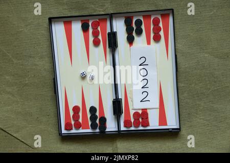 backgammon board game and text 2022 written on paper stands on the table ,hobby Stock Photo