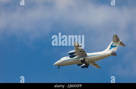 Airplane in the blue sky background. Summit Air Aircraft - C-FERJ approaching Vancouver Airport-August 2,2022. Modern technology in fast transportatio Stock Photo